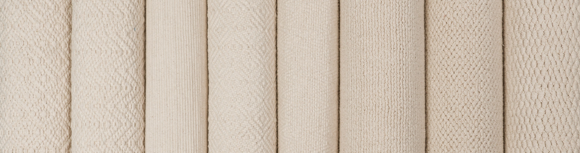 Rolls of our Cotton Organic Rugs collection, wide banner