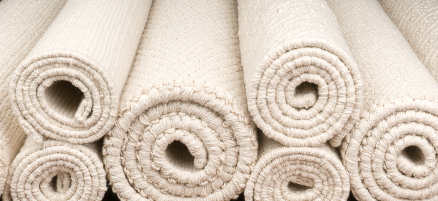 Pile of rolled rugs in our Cotton Organic Collection
