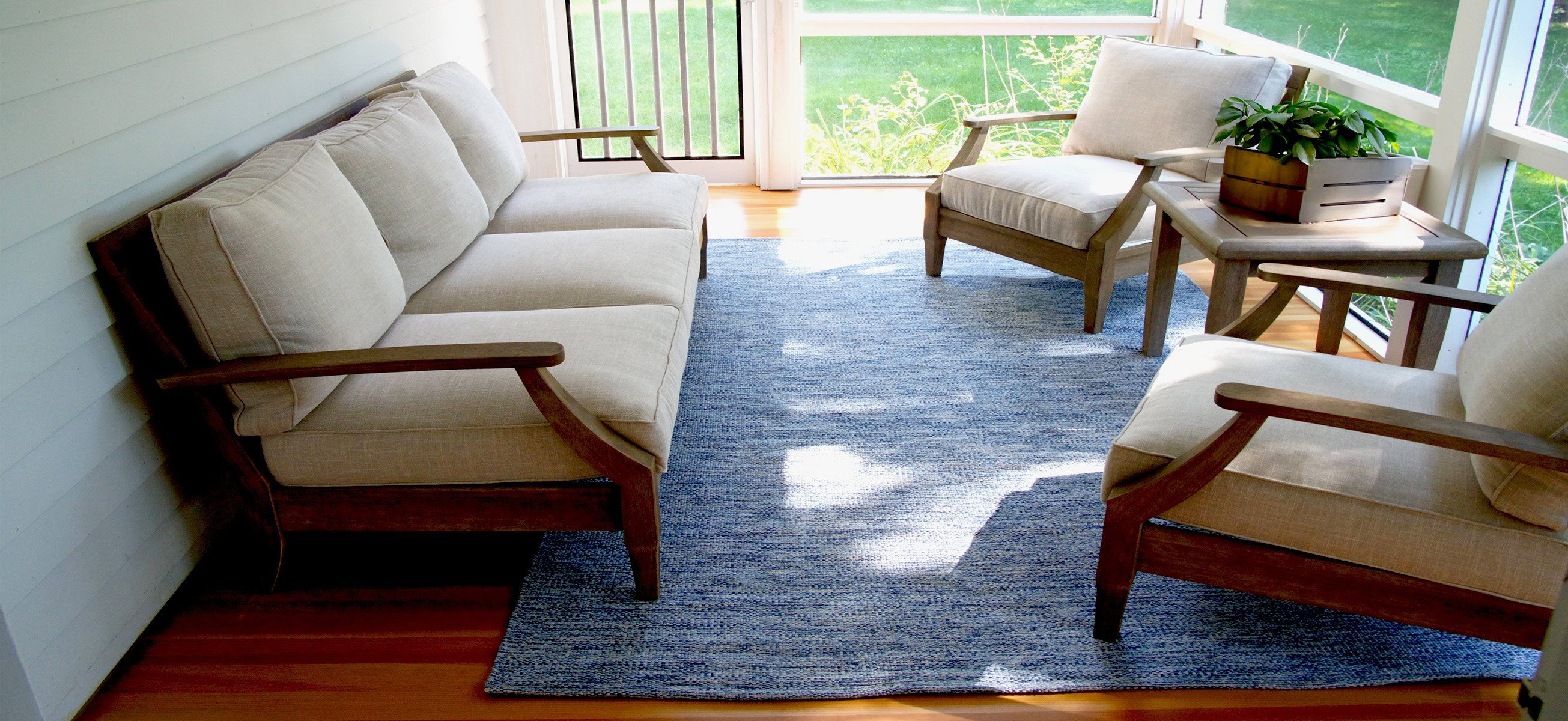 Kind of Blue 6x9 Eco Cotton Flatweave rug on a screen porch with armchairs and a small table