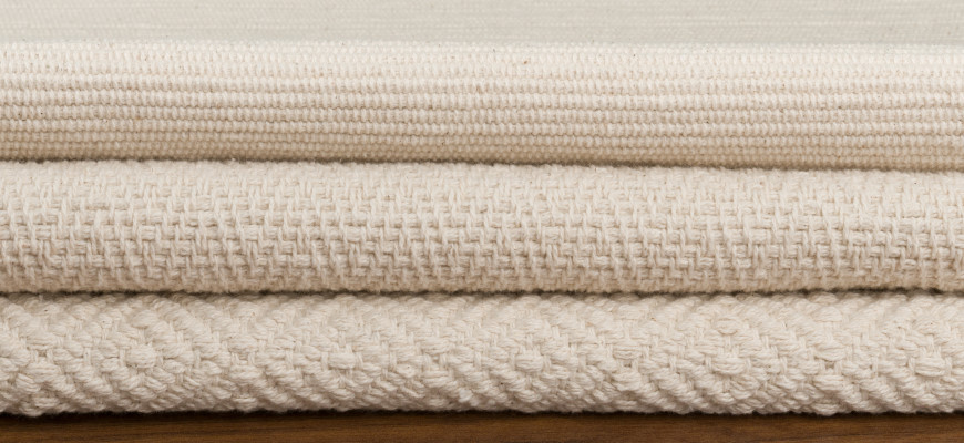 Stack of our Flatweave organic cotton rugs