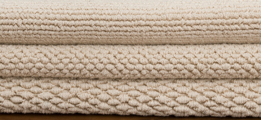 Stack of our Loom-Hooked organic cotton rugs